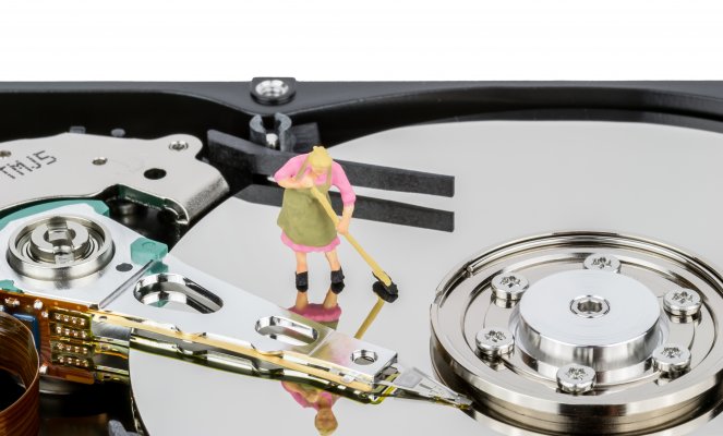 Cartoon animation woman sweeping a registry clean off of a hard drive.